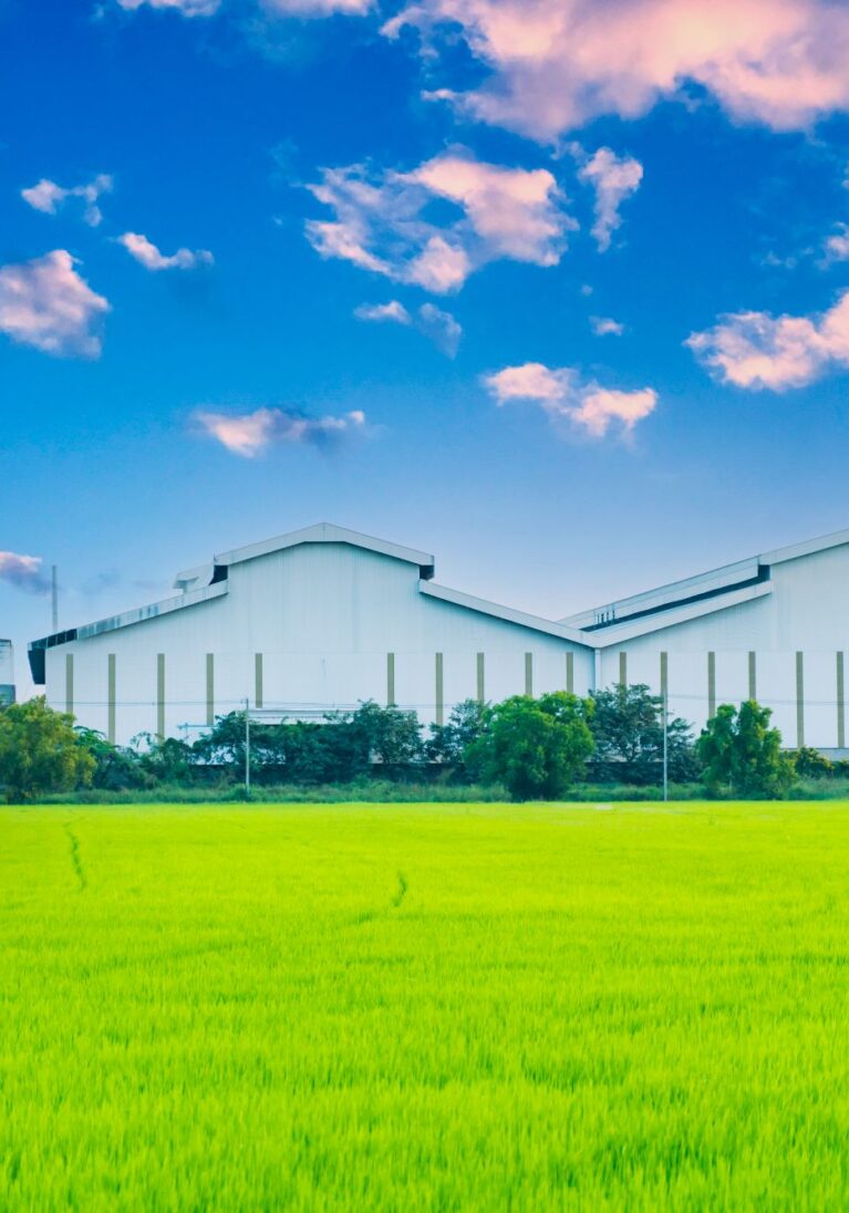 factory-with-green-fields-and-bright-sky-nature-b-2023-11-27-05-25-45-utc