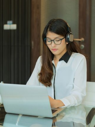 An Asian business woman using a laptop