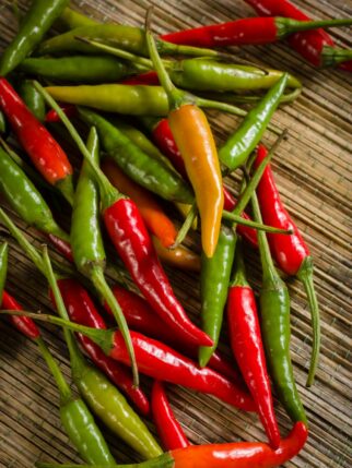 Thai red and green chilis or Prik chee fah also sometimes known as Birds Eye chile pepper fiery peppers rated at 50,000 to 100,000 scoville units